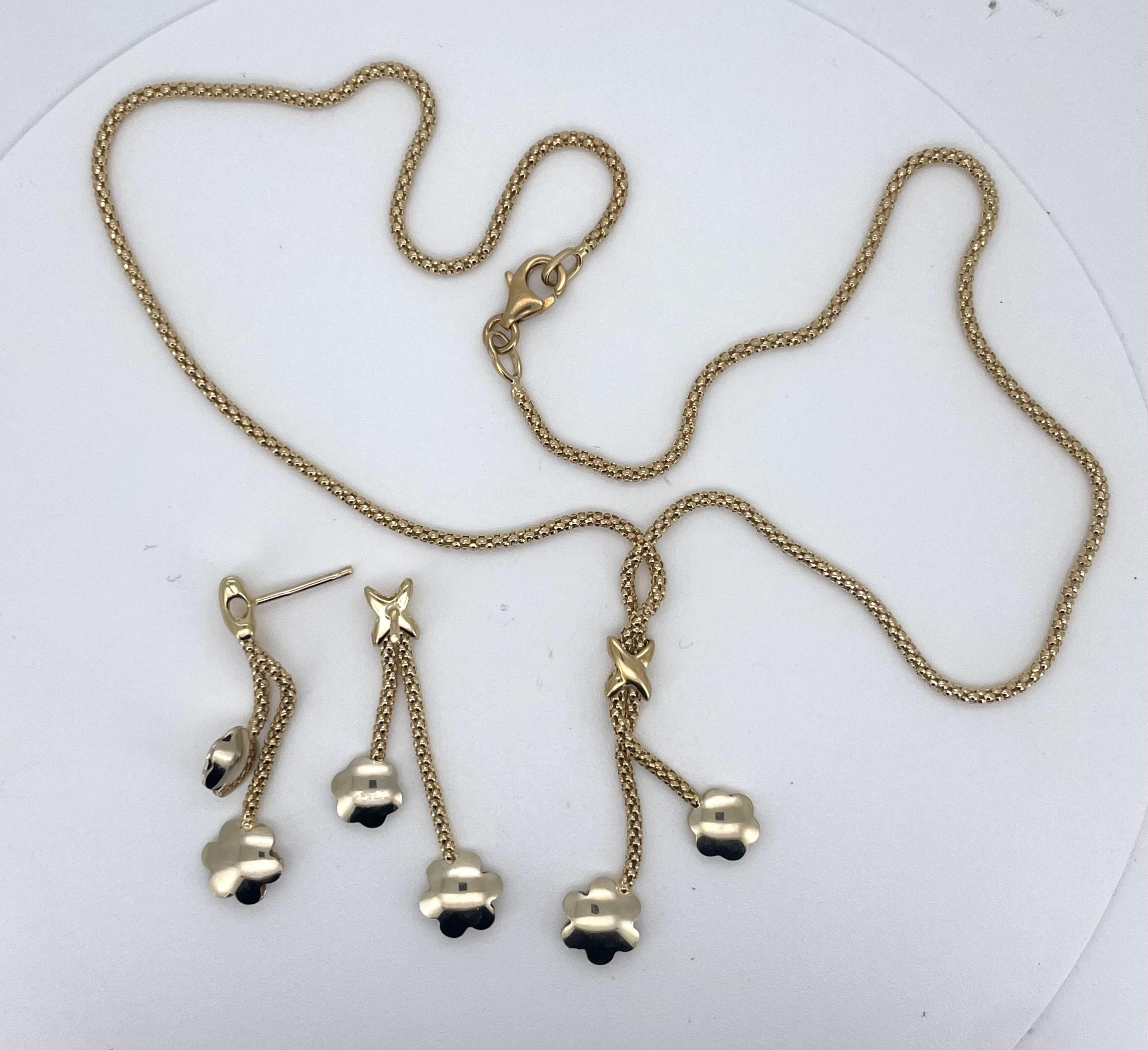 A modern yellow metal, stamped 750, necklace with two flowerhead tassel drops, overall approx. 47cm and a pair of matching drop earrings(lacking butterflies), 10 grams.